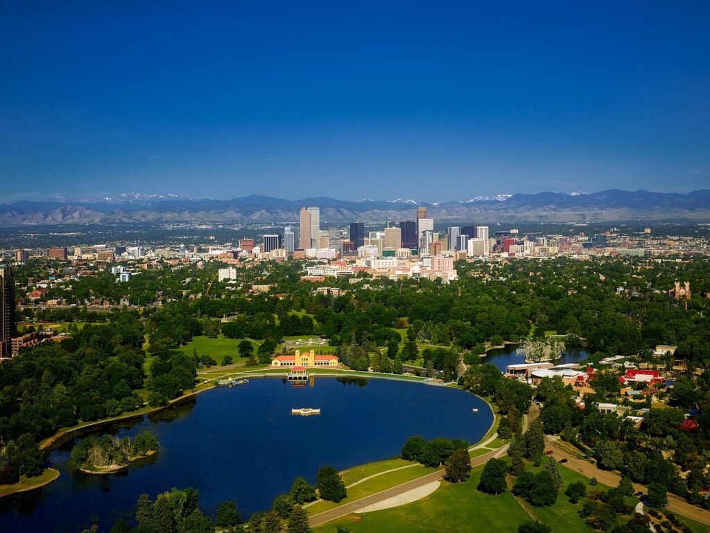 Aerial image of downtown Denver Colorado with snowcapped mountains in the background