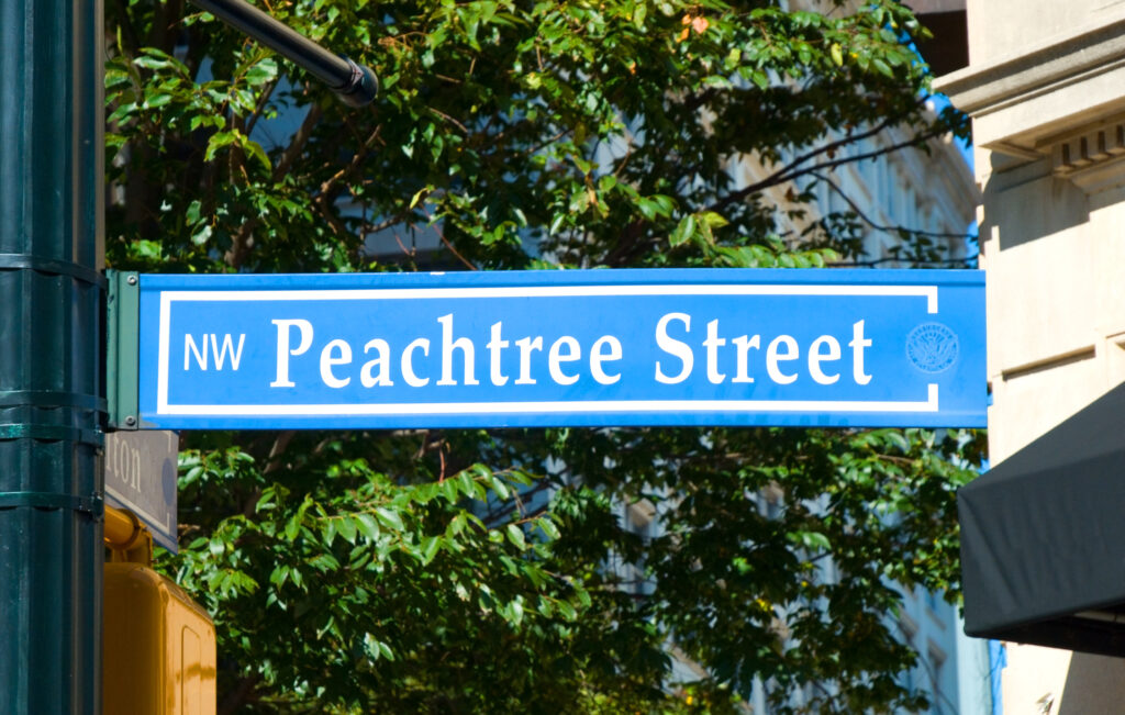 A street sign labeled Peachtree Street NW in Atlanta, Georgia