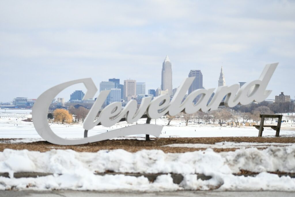 Cleveland sign in script surrounded by snow on the ground