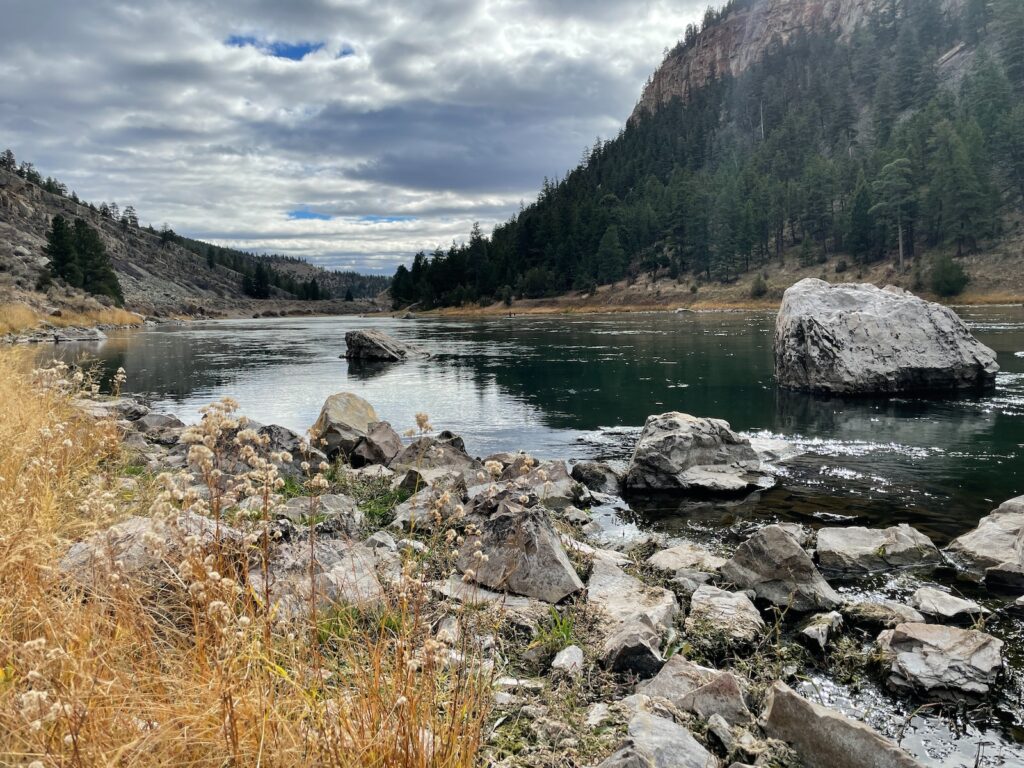 a rocky riverbed with a mountain and overcast sky in the background on the Lewis and Clark trail in Montana