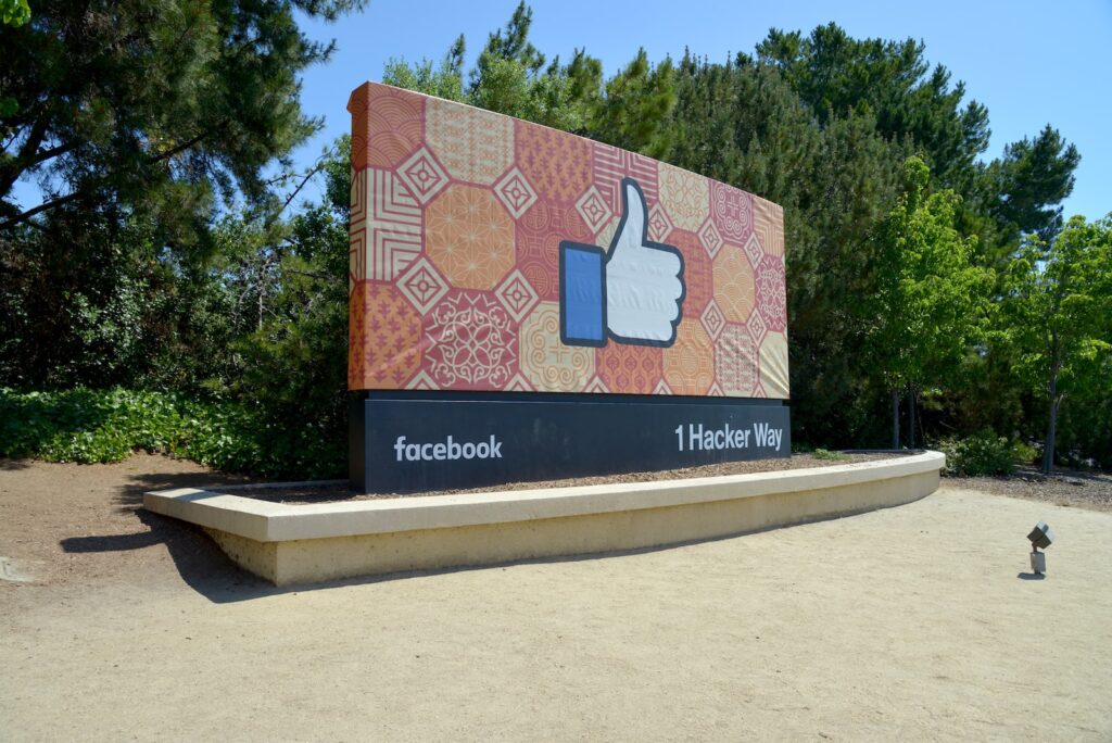 Facebook sign outside headquarters in Silicon Valley showing thumbs up emoji