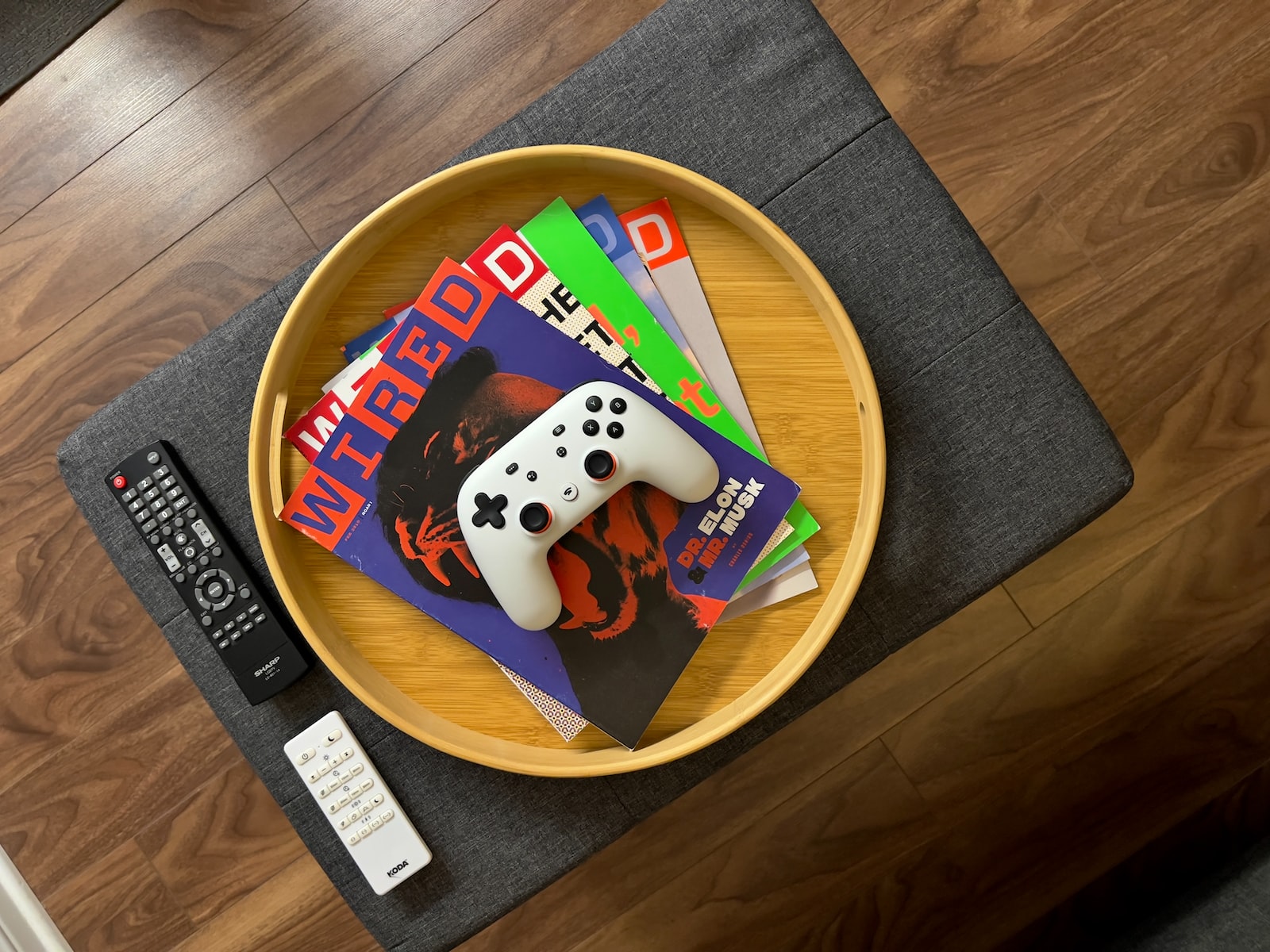 Photo of tech magazines in a bowl with a white video game controller on top