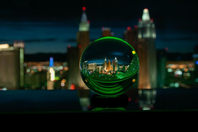 green glass ball with city lights during night time