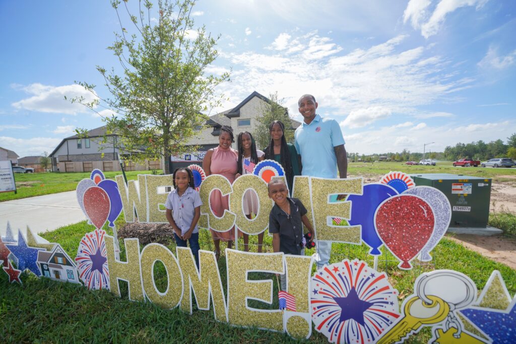 Happy family of two parents and four kids in front of a welcome home sign