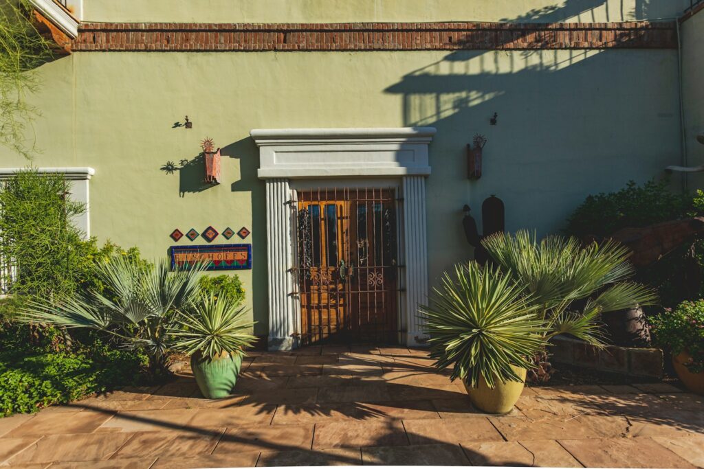 a house with a door and some plants in front of it